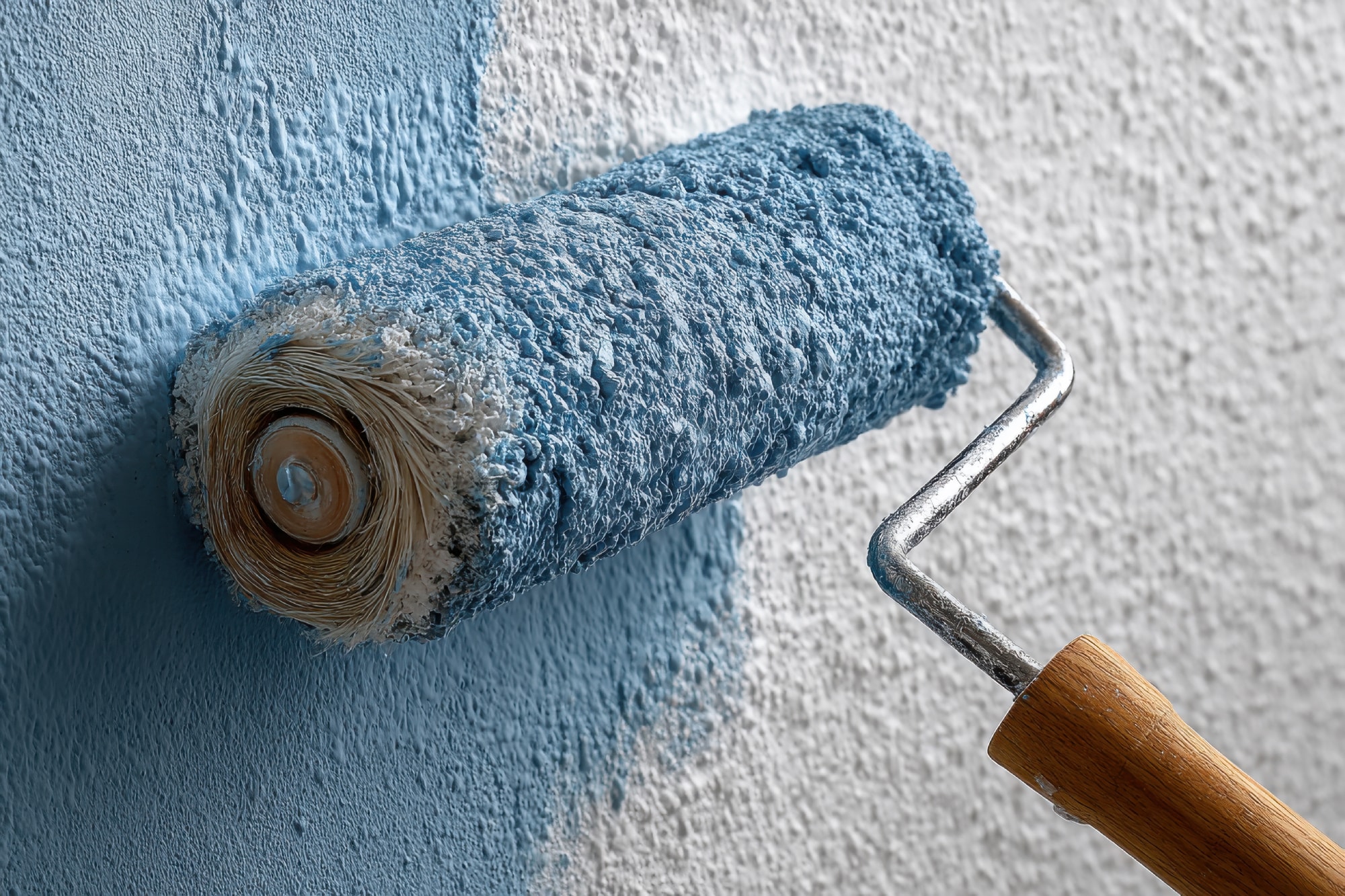 vecteezy_a-paint-roller-is-being-used-to-paint-a-wall_68570084