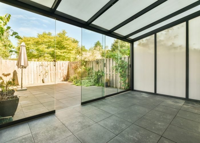 Opened,Glass,Door,Leading,Into,Terrace,From,Stylish,Living,Room